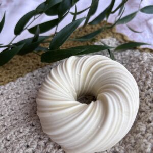 Handgjord olivtvål i beige i form av en donut med botaniskt inslag